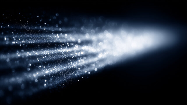 Stream of luminous particles moving through darkness, illustrating data transmission, speed, energy and digital transformation.
