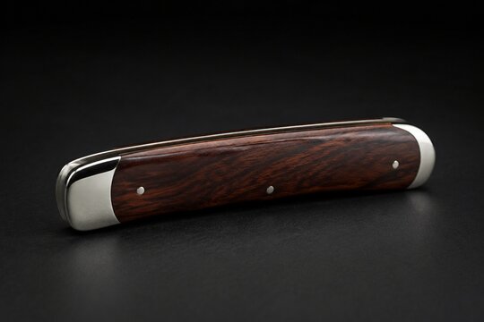 A folding knife with its blade retracted into a polished wooden handle.