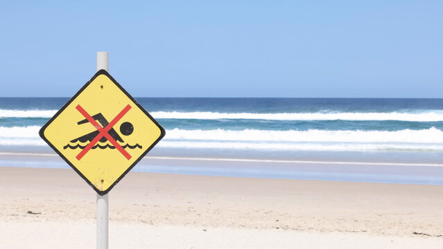 Yellow No Swimming Warning Sign on Byron Bay Beach