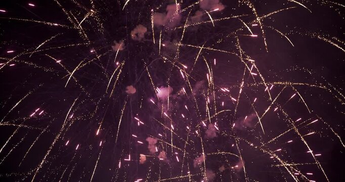 Wide Low Angle With Gold Arcing Sparks and White Glitter Bursts In Night Sky