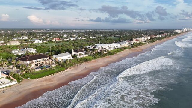 Oceanfront homes with waves breaking along Ormond Beach in Volusia County, Florida