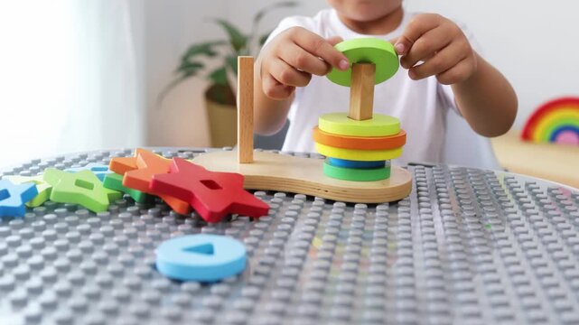 Kid playing with wood toys at preschool classroom. Kindergarten education games for children at nursery