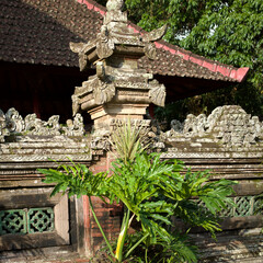 Scenic view of historic carved wall and exotic philodendron foliage in Bali © R.コタニ