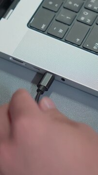 Unplugging Type-C Cable From Laptop Port Close Up Vertical 4K
