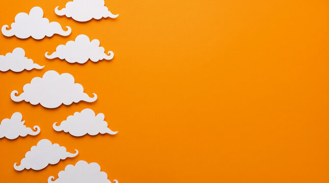 Halloween orange background featuring spooky cloud paper cut out left border, copy space for Halloween party invitation, greeting card, banner, poster, flyer and seasonal design
