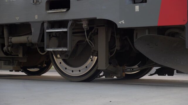a slow-motion close-up of a moving train wheel