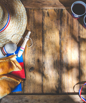Chilean independence day concept. fiestas patrias. Tipical baked empanadas, fat and play emboque. Decoration for 18 september party day, wooden background