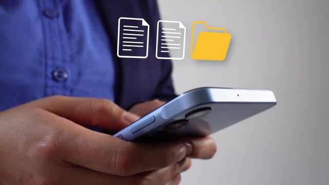 Person holds phone, taps screen with fingers and documents and folder icons float above device. User interacts with digital files, focuses on task. Ideal for business, tech, or productivity concept