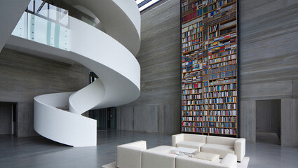 Spacious modern home library with tall spiral staircase and bookshelves interior staircase © PG Studio