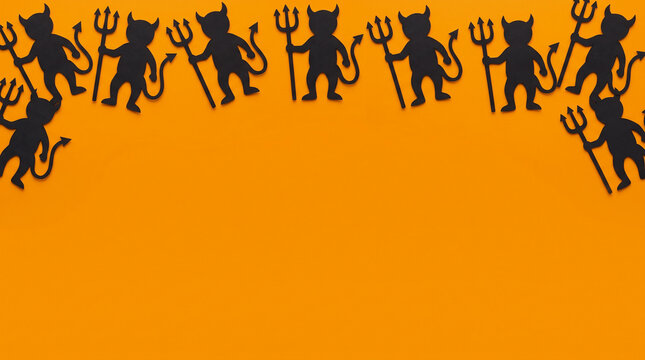 Halloween orange background featuring devil paper cut out top border, copy space for spooky party invitation, greeting card, banner, poster, flyer and eerie autumn seasonal design