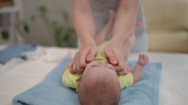 Mother giving a soothing massage to her newborn baby