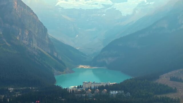 Cinematic shot revealing a beautiful Louise lake, surrounded by tall trees and mountains