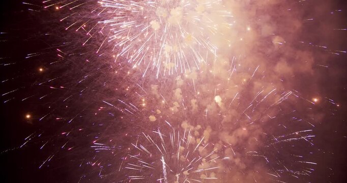 Dense Gold and Purple Firework Sparks Radiating Across Night Sky In Provo Utah