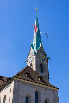 Fraumunster Church spire with clock towers and Swiss flag