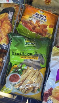 Seremban, Malaysia - June 29, 2026: A packet of Suria brand frozen Jejari Lekor Rangupp or crispy fish crackers finger alongside other frozen meat products inside a supermarket grocery freezer.