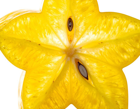 Close up macro view of fresh vibrant yellow starfruit carambola star shaped slice isolated texture background