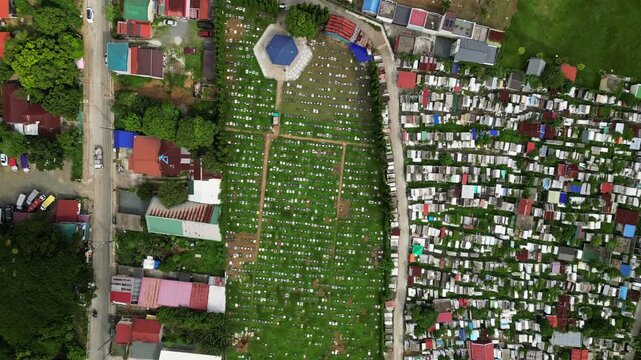 ide establishing drone footage of Alfonso Public Cemetery in Alfonso Cavite Philippines with visible memorial structures, boundary roads, and provincial town context.