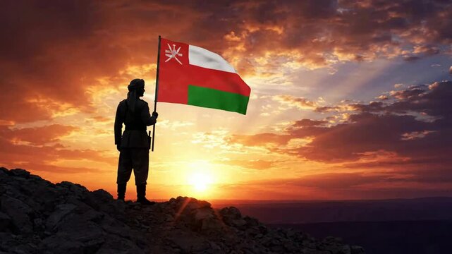 Silhouette of omani man holding national flag on mountain peak at sunset, patriotic concept, middle eastern culture and heritage celebration