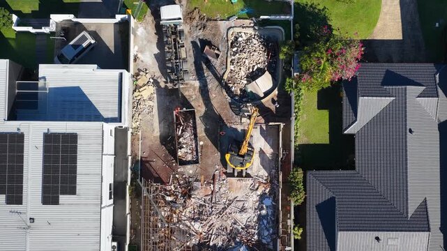 Aerial View of Residential House Demolition with Excavator and Rubble