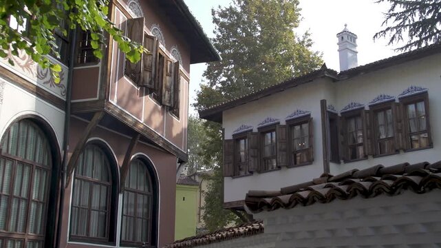 Courtyard view of Balabanov House in Plovdiv Old Town, Bulgaria. Traditional Bulgarian Revival architecture surrounded by historic buildings and autumn trees.