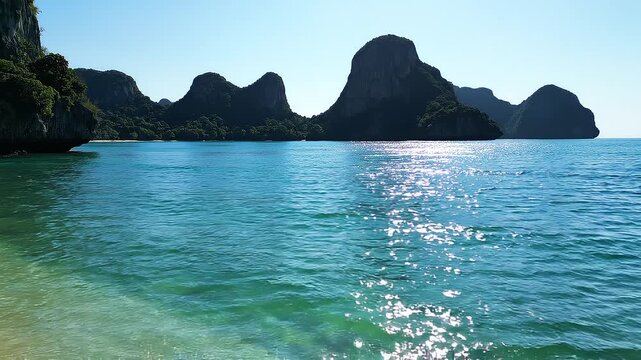Sea water washing a beautiful sandy beach in Maya Bay, Thailand, crystal-clear turquoise waves gently lapping onto pristine white sand