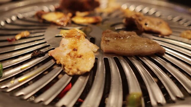 Korean BBQ scene, pork belly grilling on hot grill, smoke rising, fresh vegetables and side dishes