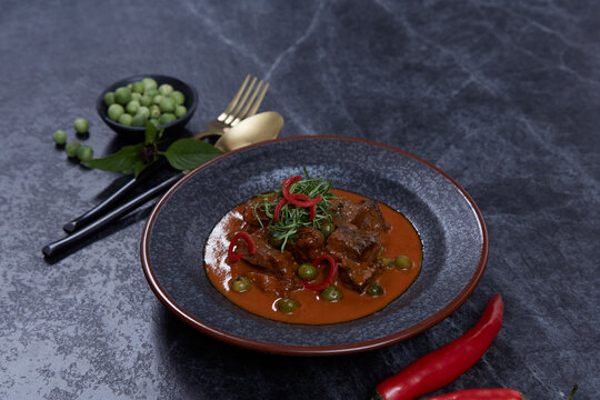 Thai cuisine, homemade beef curry Panang on black background.