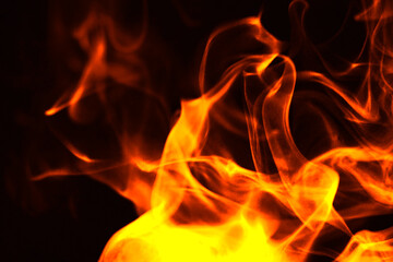 Fototapeta premium Abstract burning fire flames and smoke texture on black background