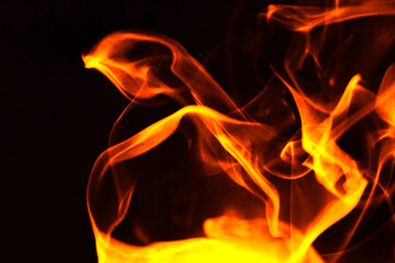 Fototapeta premium Abstract burning fire flames and smoke texture on black background