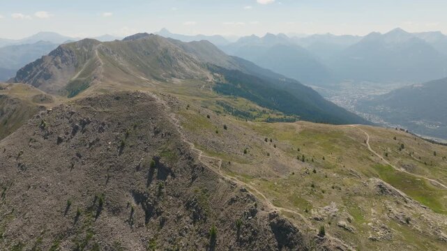 Cinematic aerial drone footage of the French Alps showcasing breathtaking mountain landscapes, dramatic peaks, lush green valleys, dense forests, and pristine alpine nature. Stunning panoramic views c