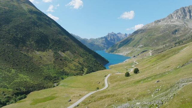Cinematic aerial drone footage of the French Alps showcasing breathtaking mountain landscapes, dramatic peaks, lush green valleys, dense forests, and pristine alpine nature. Stunning panoramic views c