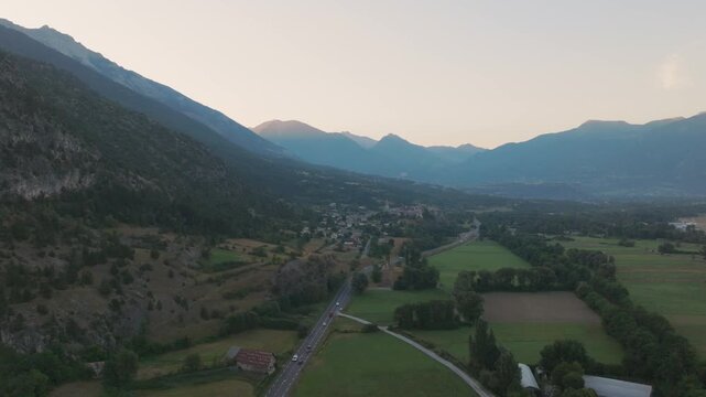 Cinematic aerial drone footage of the French Alps showcasing breathtaking mountain landscapes, dramatic peaks, lush green valleys, dense forests, and pristine alpine nature. Stunning panoramic views c