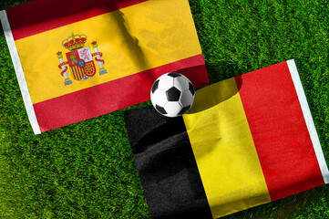 Obraz premium Spain vs Belgium, Quarterfinals, national flags before international football match, football on green grass with stadium in the background, SoFi Stadium, Inglewood, United States, July 10, 2026.