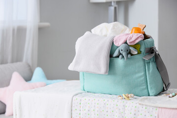 Baby bag with accessories on changing table in room