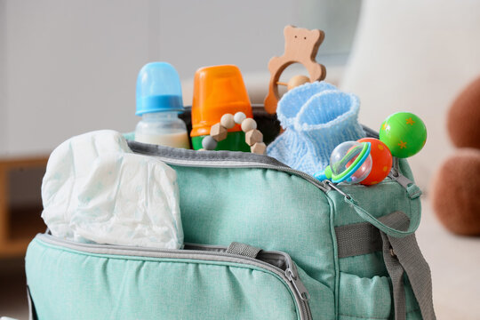 Baby bag with accessories in living room, closeup