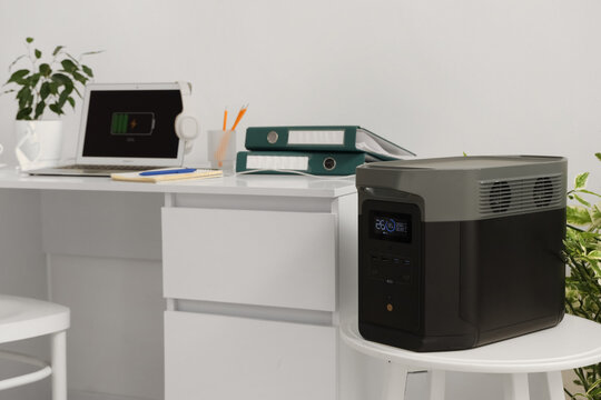 Portable power station on table near desk in office