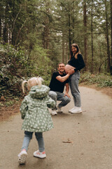 Fototapeta premium Parents with their child in the forest