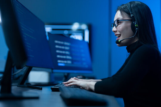 Customer service, asian female IT support engineer wearing headset working on computer code, technical helpdesk, call center, software development, cybersecurity and global corporate communications