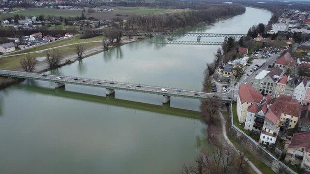Aerial view of the Inn river border bridge at Braunau in winter