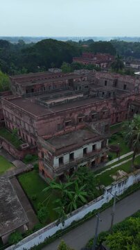 Aerial drone view ancient red brick palace ruin tropical lush greenery overcast sky historic