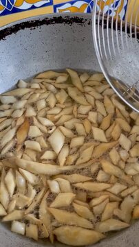 Deep frying a te time snack made with whole wheat flour called Nimki in pipping hot oil