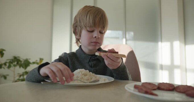 Kid Boy Eat Rice and Sausage. Eating Breakfast Lunch in Kitchen. 4K 10-bit