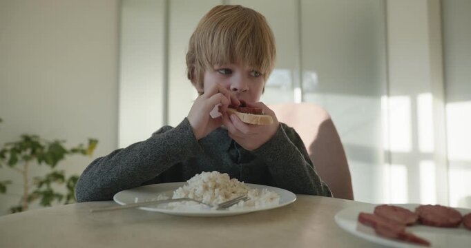 Kid Boy Eat Rice and Sausage. Eating Breakfast Lunch in Kitchen. 4K 10-bit