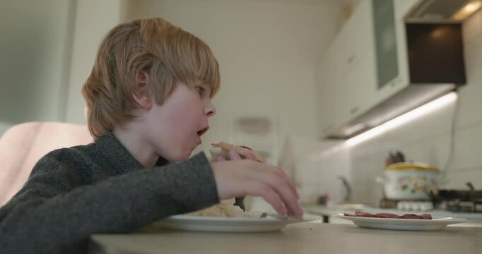 Kid Boy Eat Rice and Sausage. Eating Breakfast Lunch in Kitchen. 4K 10-bit