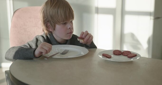 Kid Boy Eat Rice and Sausage. Eating Breakfast Lunch in Kitchen. 4K 10-bit