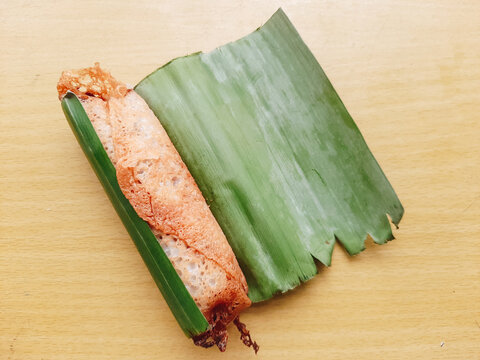 Serabi solo cake on banana leaves, isolated on a white background serabi solo is a typical Indonesian food that has a soft and sweet texture. Made from rice flour, instant yeast, granulated sugar an