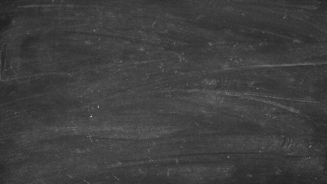 High resolution dark black chalkboard background with white dusty smudges from erased chalk surface for creative artistic design.