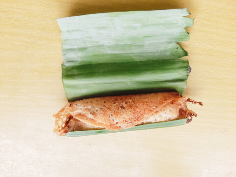 Serabi solo cake on banana leaves, isolated on a white background serabi solo is a typical Indonesian food that has a soft and sweet texture. Made from rice flour, instant yeast, granulated sugar an