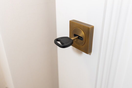 A door lock with a key, door lock repair, handyman or lock picking, protection from thieves with a handy key and lock. High quality