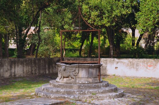 A charming historic stone well surrounded by greenery in Queen Jelena Madijevka Park, Zadar. This peaceful hidden gem offers an authentic cultural experience, ideal for travel, heritage, and travel.
